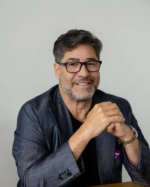 Gino DeMichele smiling, hands clasped